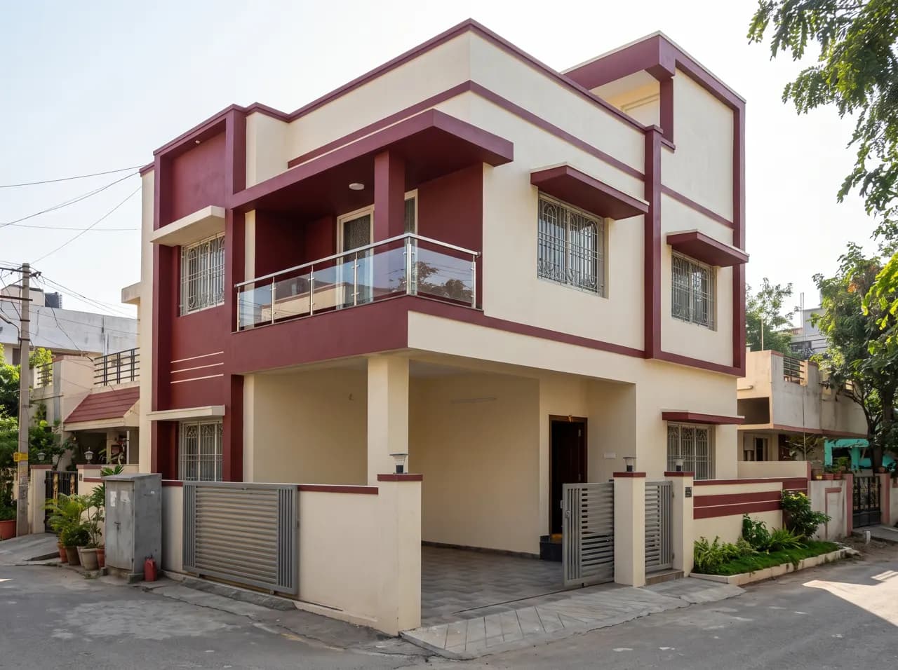 Double floor corner house elevation in cream and maroon with glass balcony