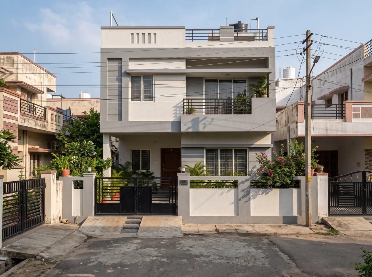 Double floor house elevation with recessed balcony and boundary wall