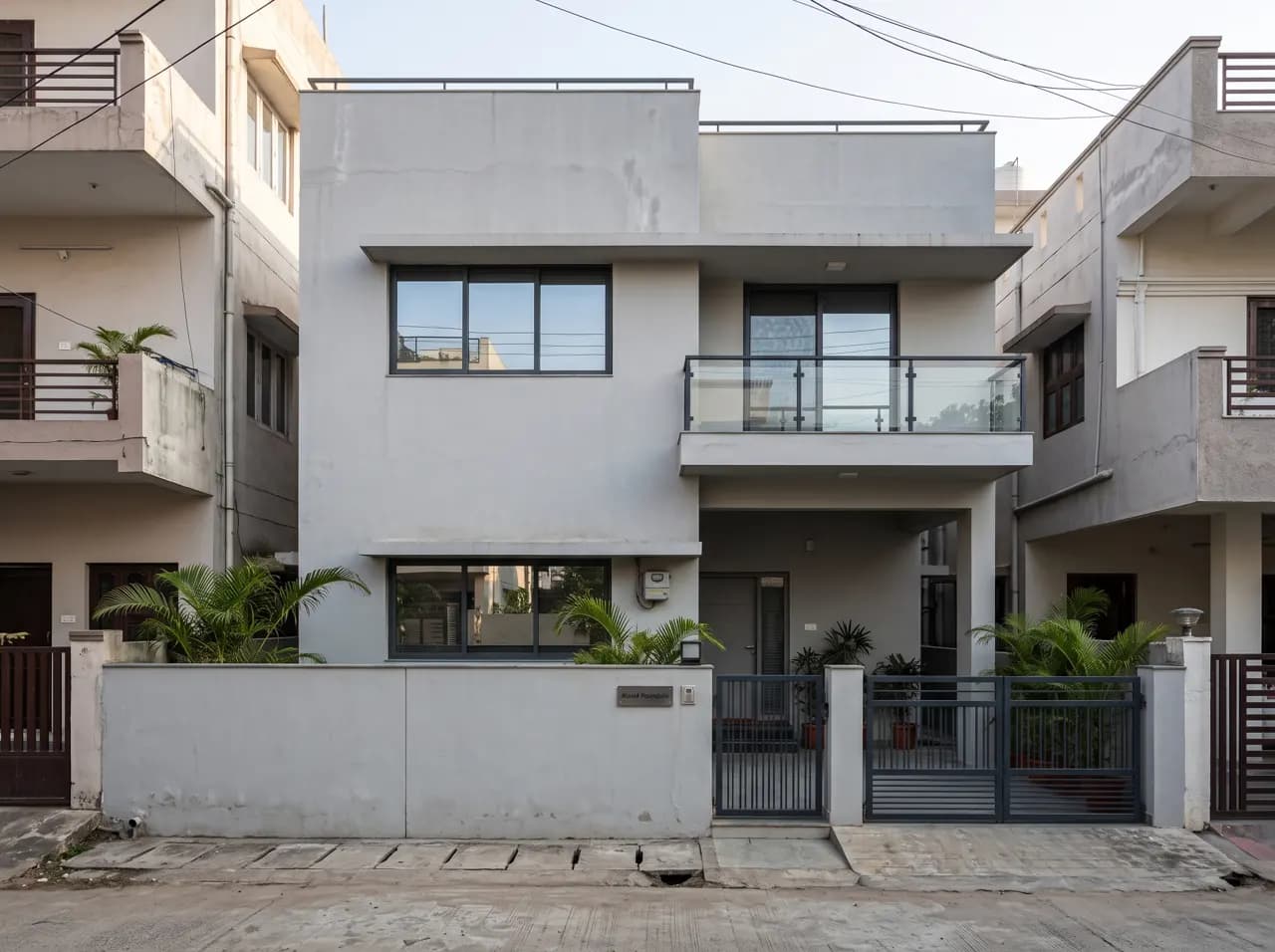 Simple two floor house front in light grey with horizontal window bands