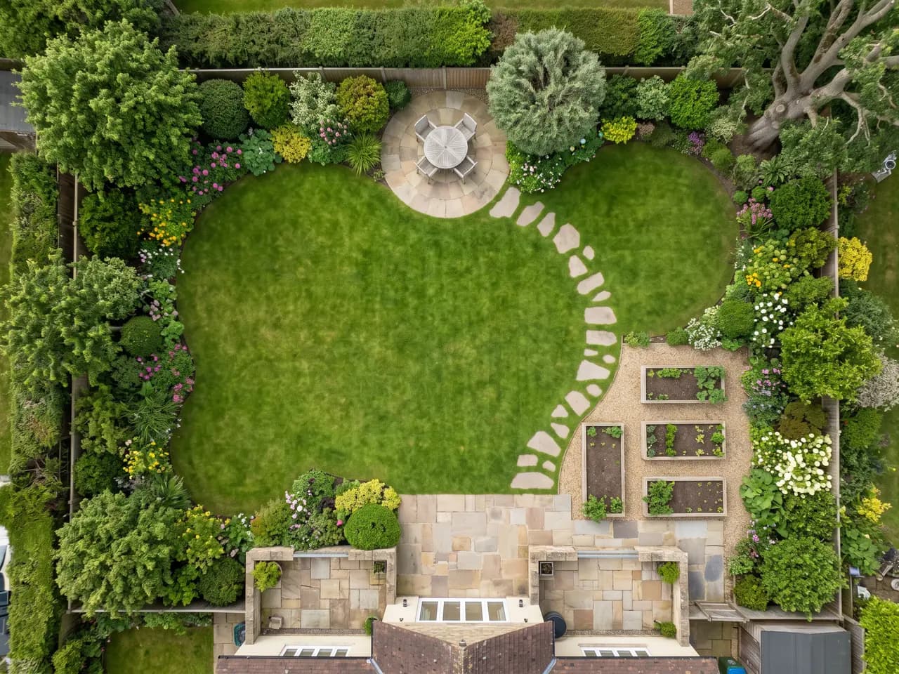 AI garden design render of a hand-drawn garden plan with lawn, borders and seating area — after